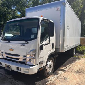 A white truck parked in the parking lot.